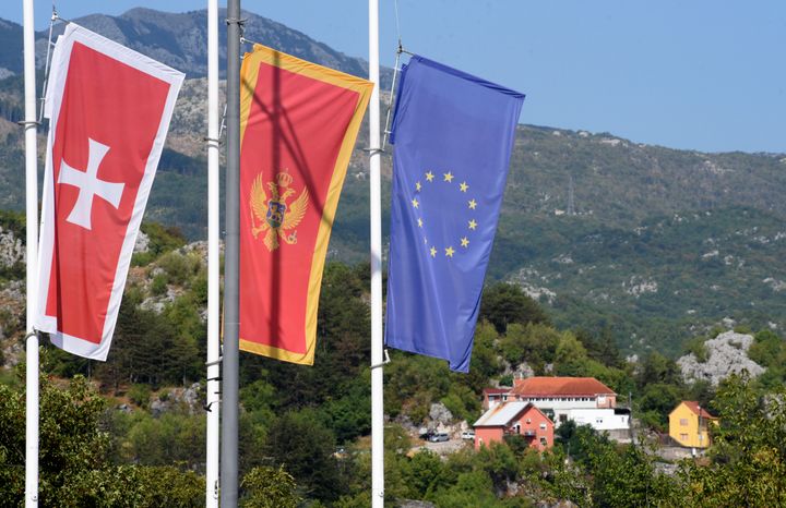 Flags flew at half-mast in front of the site of the attack in Cetinje, some 30 km west of Podgorica, Montenegro, Saturday, Aug. 13, 2022. 