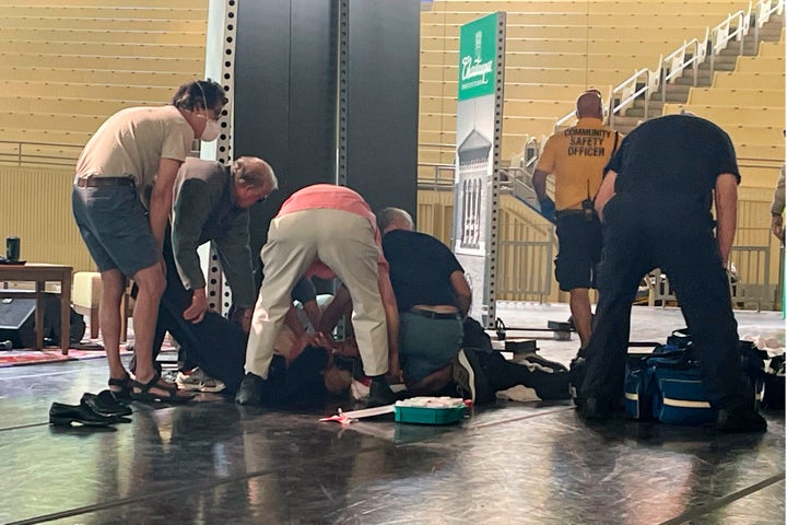 Author Salman Rushdie is tended to after he was attacked during a lecture, Friday, Aug. 12, 2022, at the Chautauqua Institution in Chautauqua, N.Y., about 75 miles south of Buffalo. (AP Photo/Joshua Goodman)