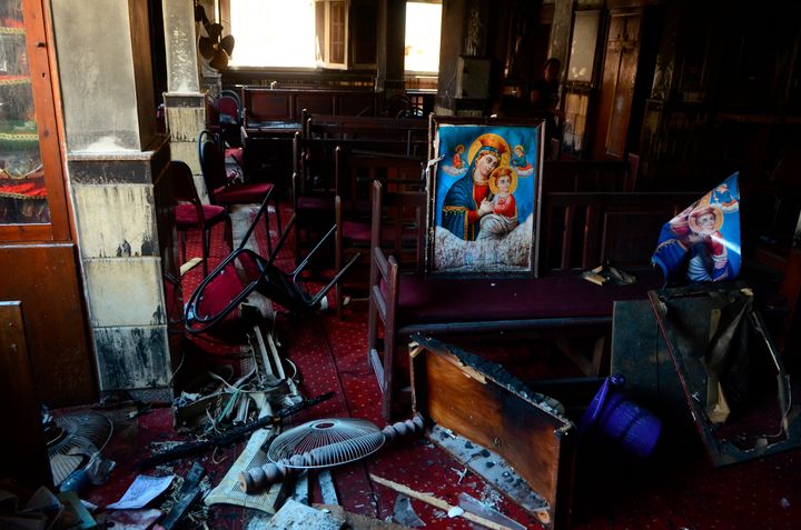 Burned furniture, including wooden tables and chairs, and a religious images are seen at the site of a fire inside the Abu Sefein Coptic church in the densely populated neighborhood of Imbaba, Cairo Egypt, Sunday, Aug. 14, 2022. (AP Photo/Tarek Wajeh)