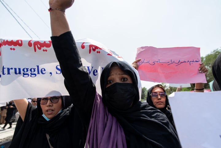 Taliban fighters fired into the air as they dispersed a rare rally by women as they chanted