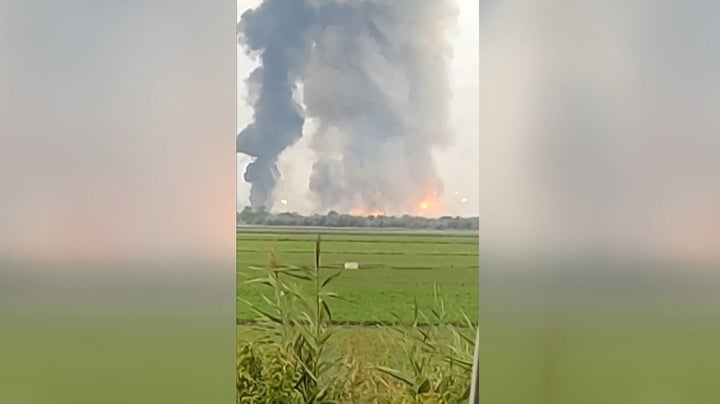 A still frame from a video taken with a smartphone shows fire and smoke billowing from munitions depot in Crimea early on August 16.