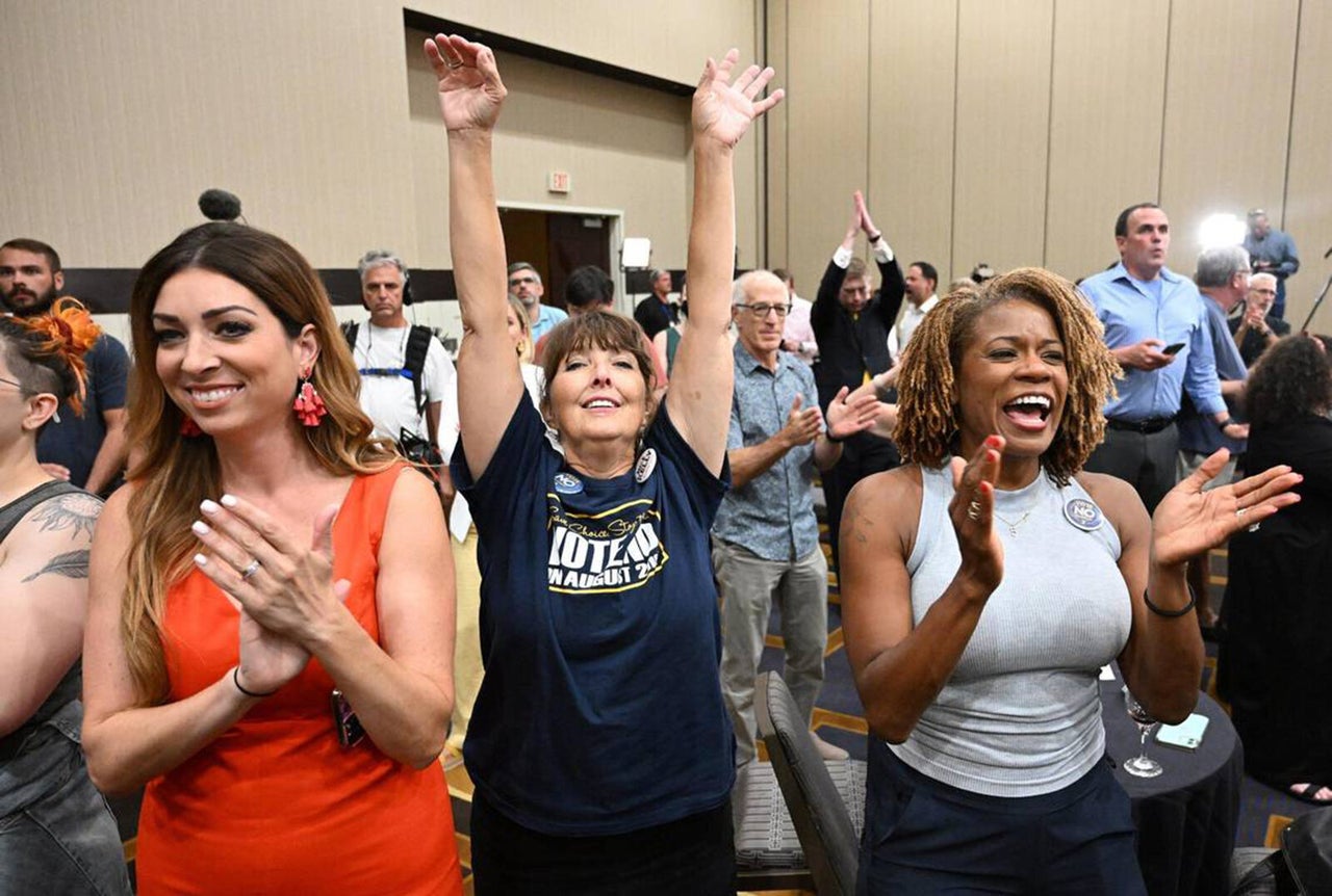 Calley Malloy, left, Cassie Woolworth and Dawn Rattan applauded the failure of a ballot initiative on Aug. 2, 2022, that would have taken away abortion rights in Kansas.