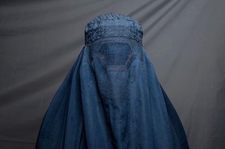 In this picture taken on July 30, 2022, shampoo factory worker Robina, 40, poses for a portrait in Kandahar. - Since their takeover a year ago, the Taliban have squeezed Afghan women out of public life, imposing suffocating restrictions on where they can work, how they can travel, and what they can wear. There is hardly a woman in the country who has not lost a male relative in successive wars, while many of their husbands, fathers, sons and brothers have also lost their jobs or seen their income shattered as a result of a deepening economic crisis.
