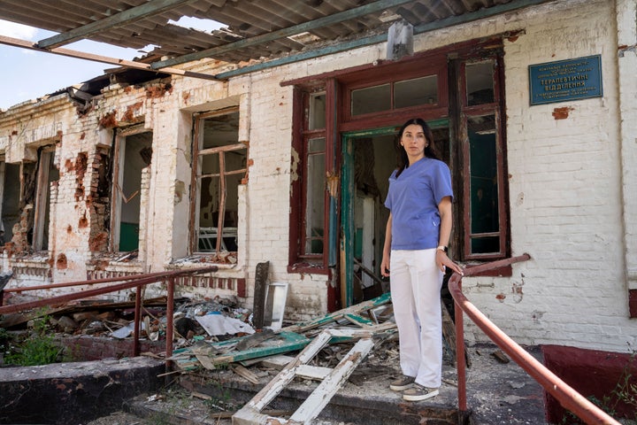 Dr. Ilona Butova stands in front of the therapy department which was destroyed after a Russia attack on the hospital in Zolochiv, Kharkiv region, Ukraine, on July 31, 2022.