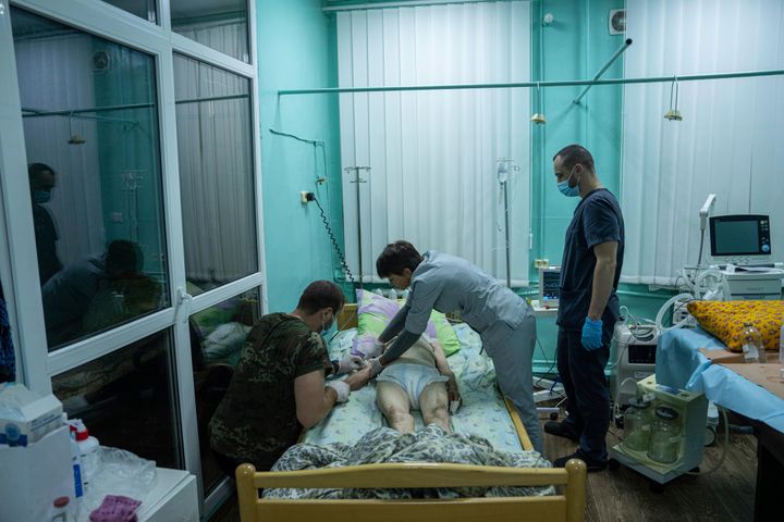 Medics treat an elderly woman at the ICU department in the hospital of Zolochiv, Kharkiv region, Ukraine, on July 31, 2022.