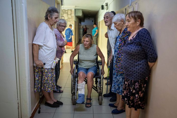 People wait to visit medics from the Ukrainian Red Cross at the center for displaced persons near Mykolaiv, Kharkiv region, Ukraine, on Aug. 8, 2022. 