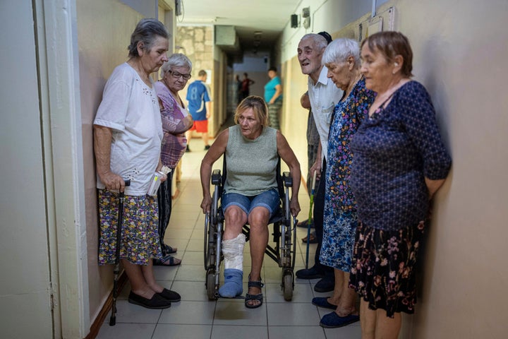 People wait to visit medics from the Ukrainian Red Cross at the center for displaced persons near Mykolaiv, Kharkiv region, Ukraine, on Aug. 8, 2022.