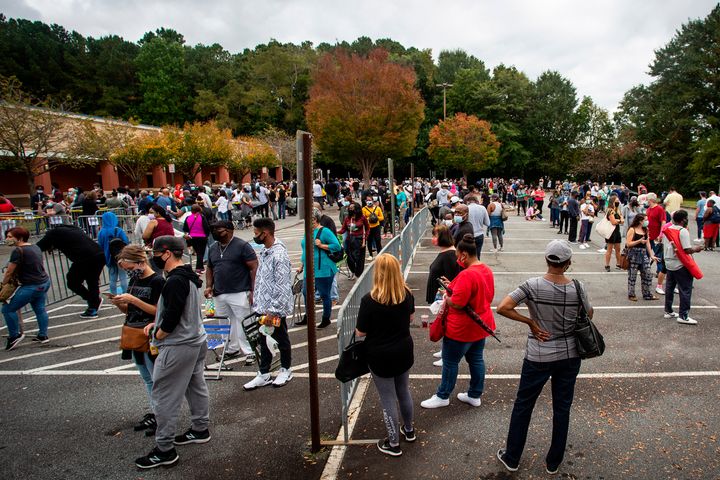 Hundreds of people wait in line for early voting on Oct. 12, 2020, in Marietta, Georgia.