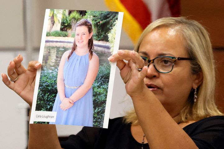 Family friend Isabel Dalu holds a photograph of Cara Loughran, who died in the shooting, before giving a victim impact statement on behalf of the Loughran family at the Broward County Courthouse in Fort Lauderdale on August 3.