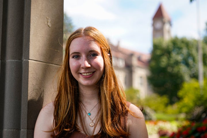 Emily Korenman, freshman, 18, from Dallas, poses at the Sample Gates at Indiana University in Bloomington, Ind., Tuesday, Aug. 16, 2022. Korenman, who decided to study business at Indiana University, said she was frustrated to learn her new state passed new abortion restrictions that take effect Sept. 15 and allow limited exceptions. The 18-year-old said it didn't change her mind about attending a school she really likes, but she isn’t sure what she would do if she became pregnant during college. (AP Photo/Michael Conroy)