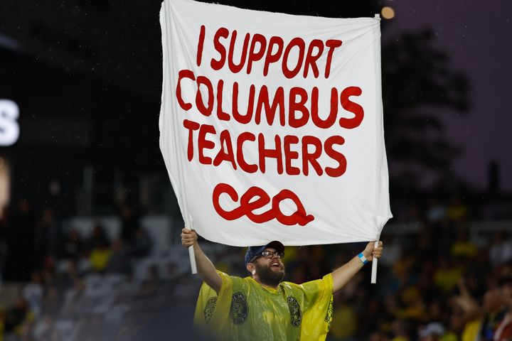A man holds a sign in support of Columbus teachers ahead of the vote to strike on August 21, 2022 in Columbus, Ohio. (Photo by Graham Stokes/Icon Sportswire via Getty Images)