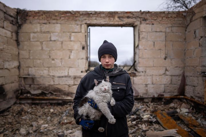 Danyk Rak, 12, holds a cat standing on the debris of his house destroyed by Russian forces' shelling in the village of Novoselivka, near Chernihiv, Ukraine, April 13, 2022. Danyk's family home was destroyed and his mother seriously wounded as Russian forces bombarded Kyiv’s suburbs and surrounding towns in a failed effort to seize the capital.