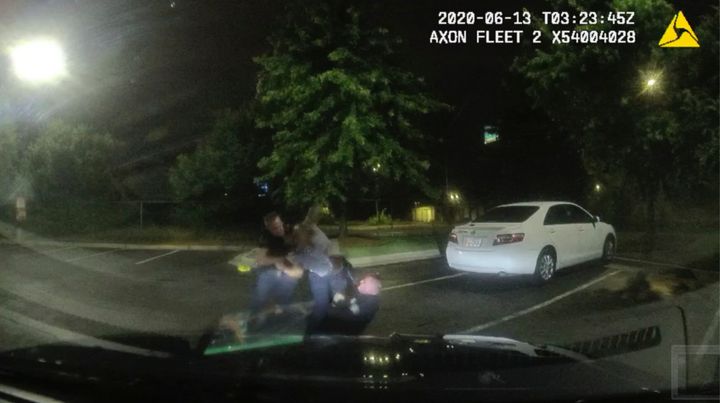 FILE - This screen grab taken from dashboard camera video provided by the Atlanta Police Department shows Rayshard Brooks, center, struggling with Officers Garrett Rolfe, left, and Devin Brosnan in the parking lot of a Wendy's restaurant in Atlanta, June 13, 2020. A specially appointed prosecutor said Tuesday, Aug. 23, 2022, that he will not pursue any charges against the Atlanta police officer who fatally shot Brooks more than two years ago. (Atlanta Police Department via AP, File)