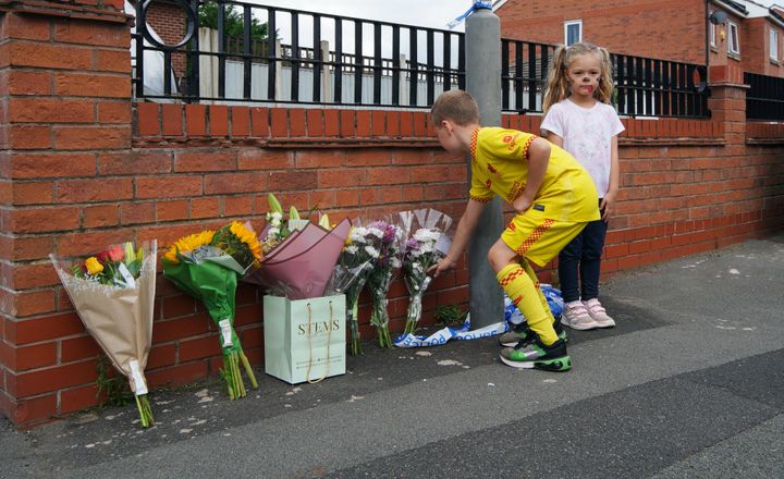 Children leave flowers near to the scene in Kingsheath Avenue, Knotty Ash, Liverpool, where nine-year-old Olivia Pratt-Korbel has been fatally shot.
