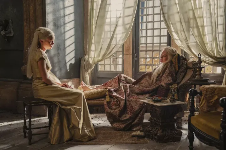 Queen Aemma Targaryen sits with her daughter, Princess Rhaenyra (Milly Alcock).