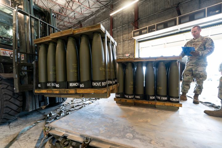 U.S. Air Force Staff Sgt. Cody Brown, right, with the 436th Aerial Port Squadron, checks pallets of 155 mm shells ultimately bound for Ukraine, April 29, 2022, at Dover Air Force Base, Del. U.S. officials say that as Russia’s war on Ukraine drags on, U.S. security assistance is shifting to a longer-term campaign that will likely keep more American military troops in Europe into the future. They say a new aid package to be announced includes an additional roughly $3 billion to train and equip Ukrainian forces to fight for years to come.