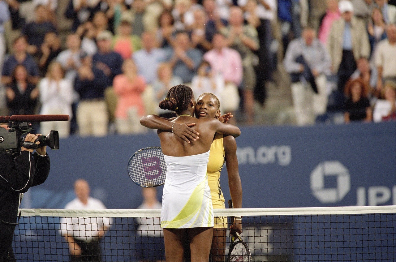 Williams and her sister Venus Williams hug at a tennis facility in New York City on Sept. 8, 2001.