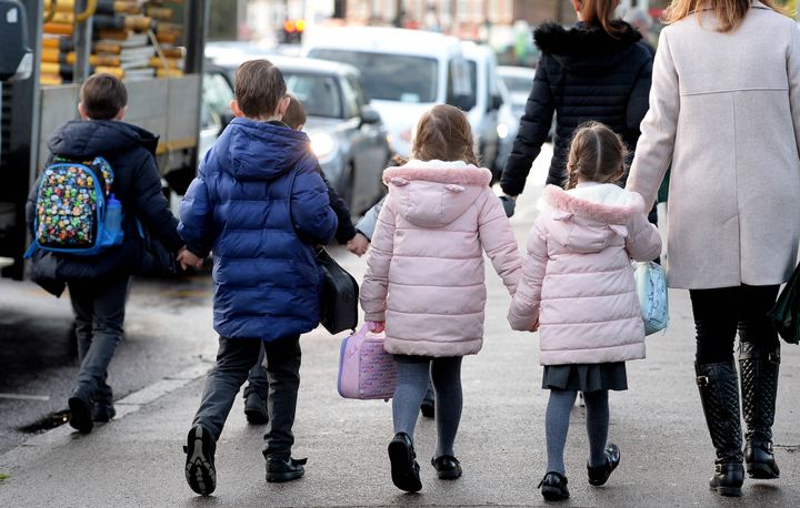 Parents walking their children to school.