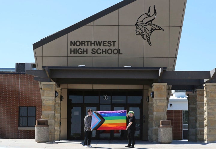 Former Viking Saga staff members Marcus Pennell (left) and Emma Smith display a pride flag outside of Northwest High School in Grand Island, Nebraska. 