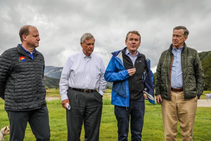 Colorado Gov. Jared Polis, U.S. Agriculture Secretary Tom Vilsack, and U.S. Sens. Michael Bennet and John Hickenlooper are pictured at Camp Hale in Colorado on Aug. 16.
