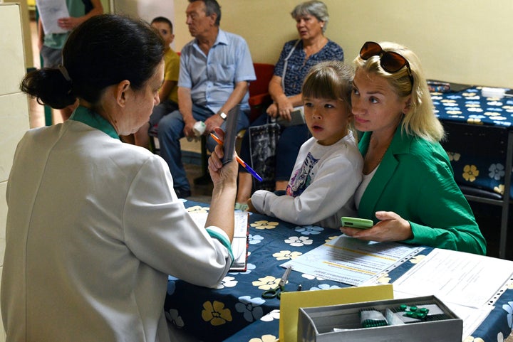 People receive iodine-containing tablets at a distribution point in Zaporozhye, Ukraine, Friday, August 26, 2022.