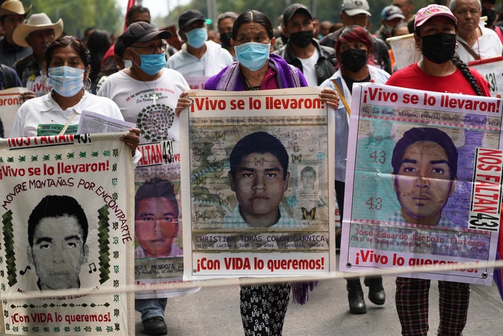 Family members and friends march seeking justice for the missing 43 Ayotzinapa students in Mexico City, Friday, Aug. 26, 2022.