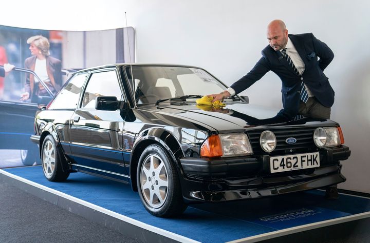 Arwel Richards, a classic car specialist at Silverstone Auctions, polishes the Ford Escort ahead of auction.