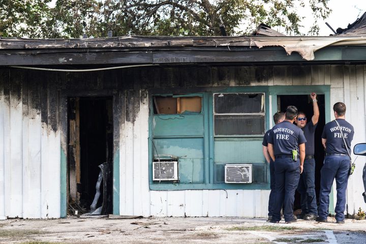 Firefighters investigate the scene of a burned out apartment building in the aftermath of a fatal shooting in Houston on Sunday, Aug. 28, 2022. A longtime tenant started several fires at the site early Sunday and then shot at residents as they fled the blaze, before authorities fatally shot him, police said.
