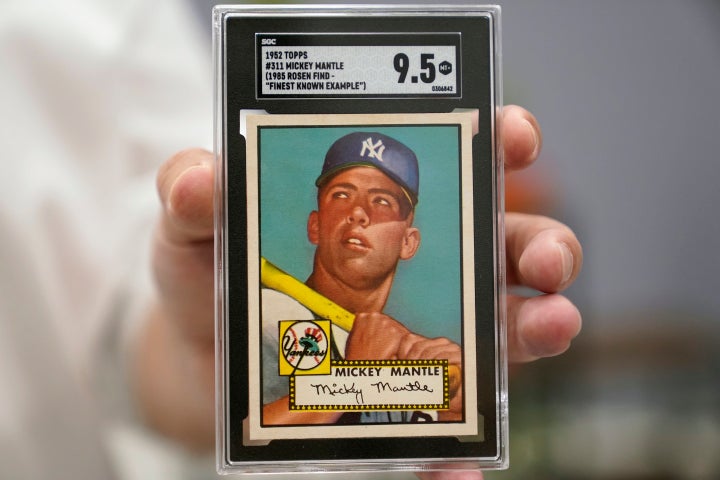 FILE - A Mickey Mantle baseball card is displayed at Heritage Auctions in Dallas, on July 21, 2022. A mint condition Mickey Mantle baseball card has sold for $12.6 million, blasting into the record books Sunday Aug. 28, 2022 as the most expensive ever paid for a piece of sports memorabilia. (AP Photo/LM Otero, File)