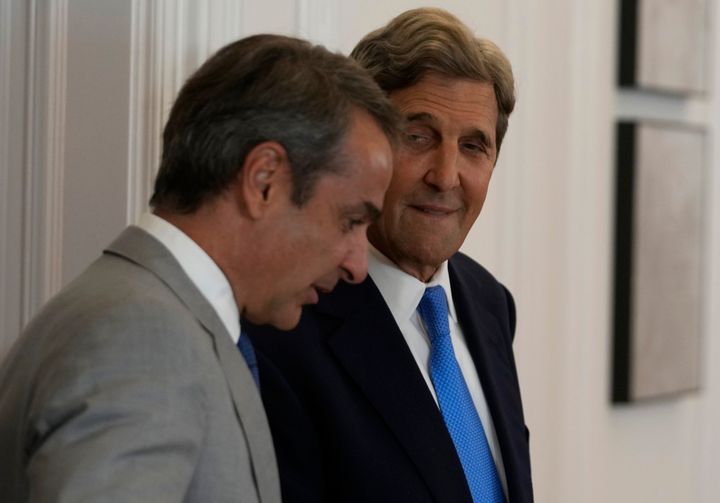 Greece's Prime Minister Kyriakos Mitsotakis, left, and Special US Presidential Envoy for Climate John Kerry arrive for their meeting at Maximos Mansion in Athens, Greece, Monday, Aug. 29, 2022. Kerry will travel after Greece to Bali, Indonesia, to attend the G20 Climate and Environment Ministerial Meeting. (AP Photo/Thanassis Stavrakis)