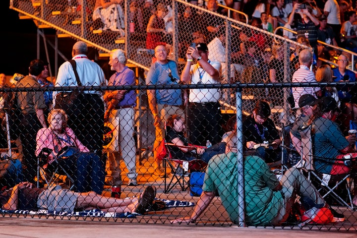 People are seen gathered ahead of Monday morning's scheduled launch.