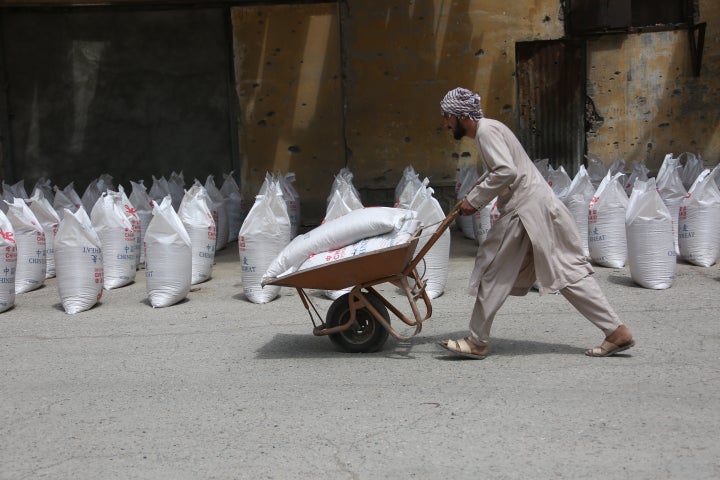 A man receives China-donated food aid in Kabul, Afghanistan, Aug. 17, 2022. A total of 1,100 needy Afghan families received food aid in the capital city of Kabul on Wednesday, said Mufti Habibullah, a senior official from the Afghan Ministry of Refugees and Repatriation Affairs. The Chinese government's humanitarian assistance is distributed to a total of 1,100 households, including internally displaced people, needy families and those who were affected by a natural disaster, particularly the latest heavy rainfalls and floods, Habibullah told Xinhua. (Photo by Saifurahman Safi/Xinhua via Getty Images)