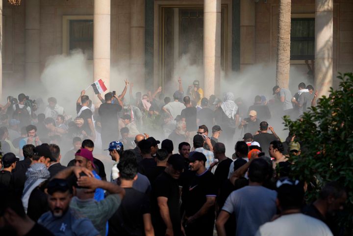 Iraqi security forces fire tear gas on the followers of Shiite cleric Muqtada al-Sadr inside the government Palace, Baghdad, Iraq, on Aug. 29, 2022. Al-Sadr, a hugely influential Shiite cleric, announced he will resign from Iraqi politics and his angry followers stormed the government palace in response. The chaos Monday sparked fears that violence could erupt in a country already beset by its worst political crisis in years. 