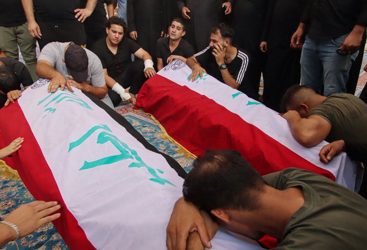 Iraqi mourners attend a mass funeral, for supporters of Shiite leader Moqtada Sadr who were killed during clashes in Baghdad's Green Zone, at a cemetery in the central Iraqi city of Najaf on Aug. 30, 2022.