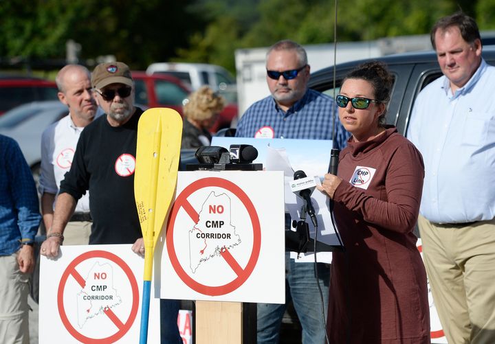 At a 2018 rally in Augusta, Maine, Kimberly Lyman, a whitewater rafting guide, speaks out against CMP's New England Clean Energy Connect, a 145-mile transmission line through Maine to bring electricity to Massachusetts residents.