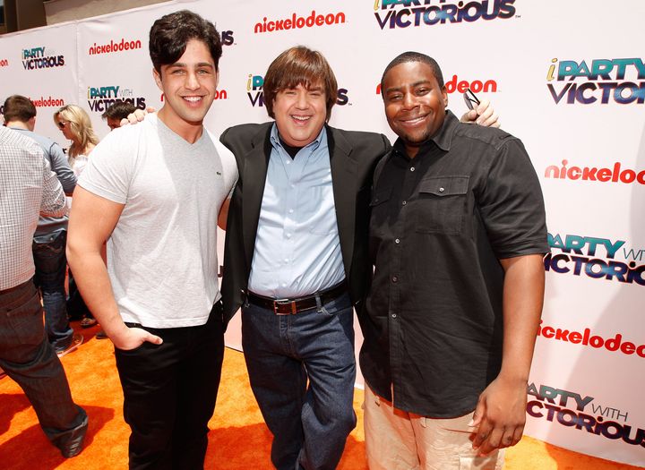 Producer Dan Schneider (center) poses for a photo with actor Josh Peck (left) and actor Kenan Thompson (right) at a Nickelodeon premiere in 2011. Schneider is accused of misconduct in a report from Insider.