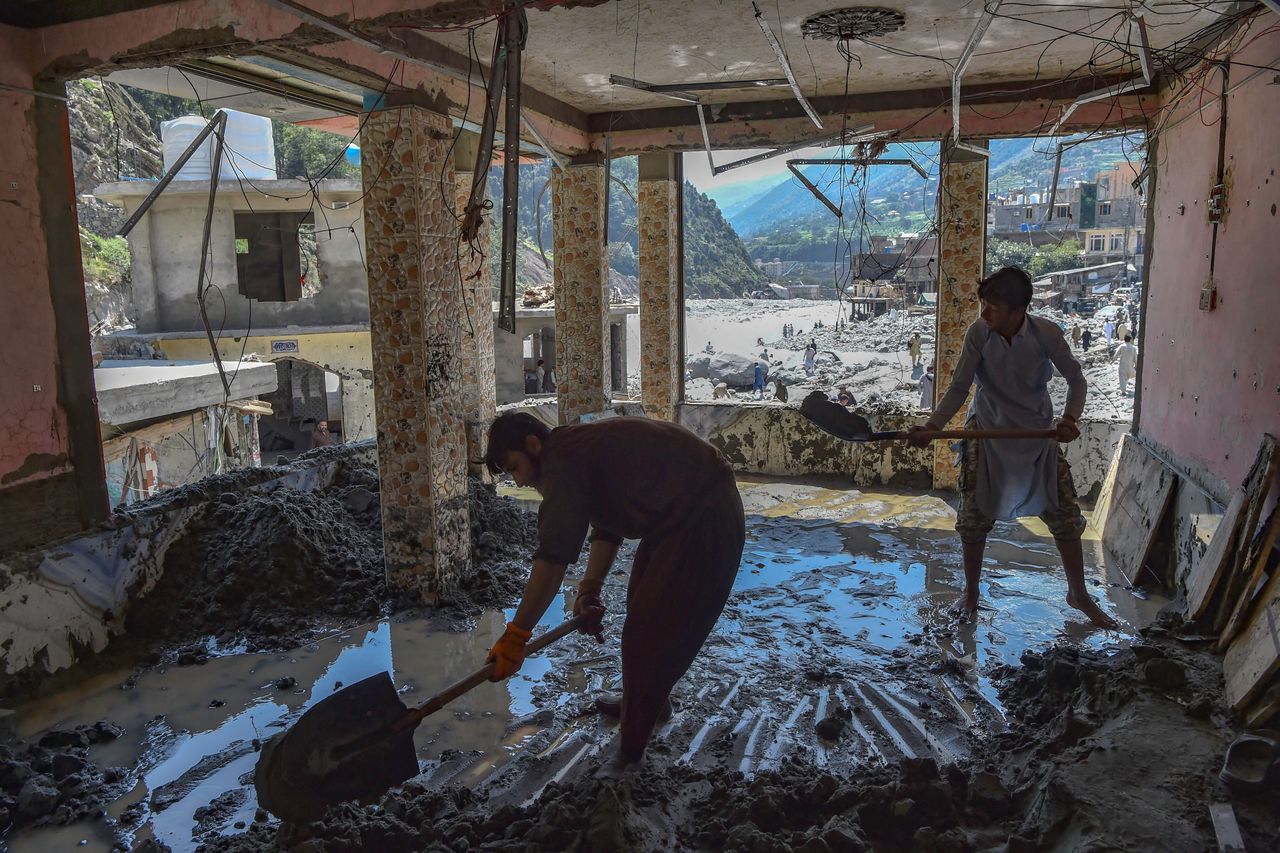 Workers clear sand from a hotel that was damaged by flash floods near the banks of river Swat after heavy rains in Bahrain town of Swat valley in Khyber Pakhtunkhwa province on Aug. 31, 2022. Army helicopters flew sorties over cut-off areas in Pakistan's mountainous north on August 31 and rescue parties fanned out across waterlogged plains in the south as misery mounted for millions trapped by the worst floods in the country's history.