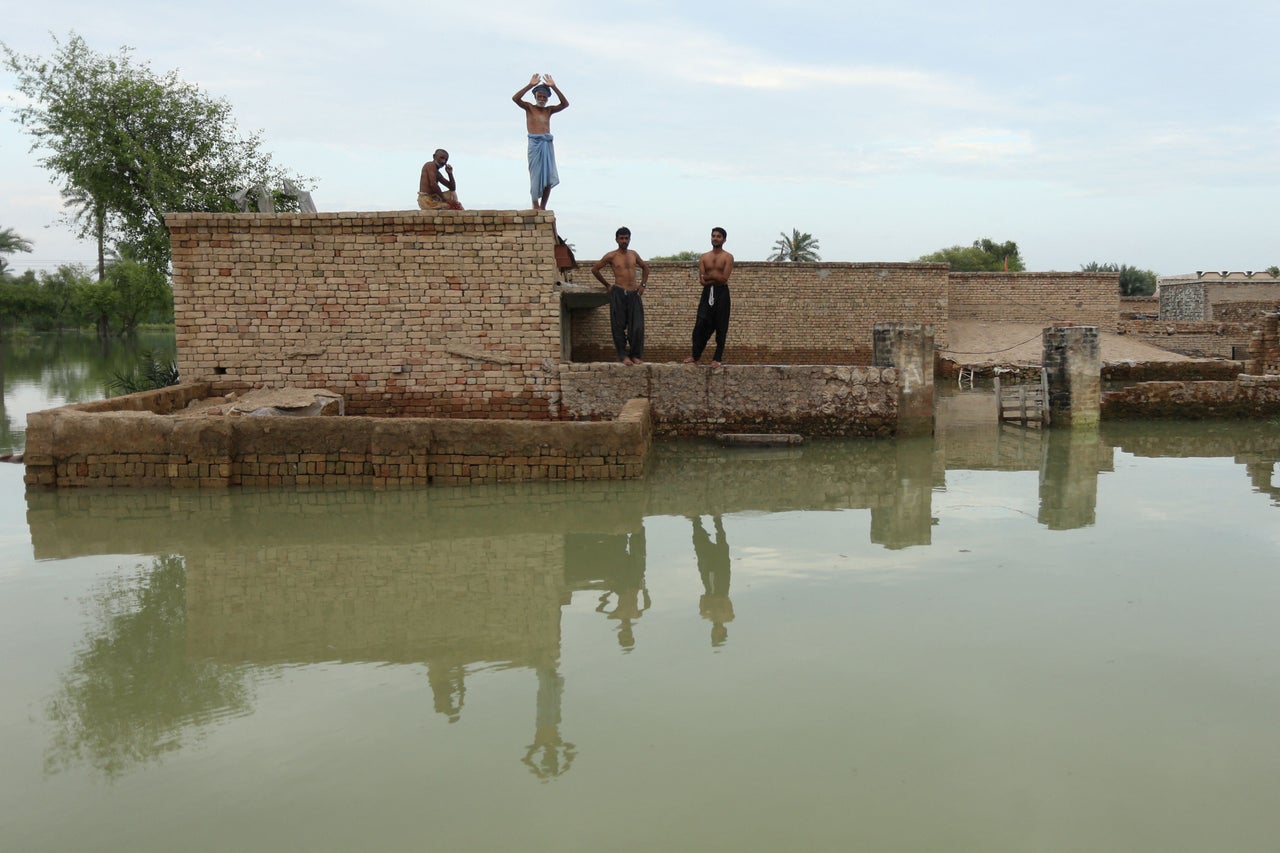 Flood-affected people wait for relief supplies in Dera Ghazi Khan district in Punjab province on Aug. 29, 2022. Tens of millions of people across Pakistan were battling the worst monsoon floods in a decade, with countless homes washed away, vital farmland destroyed and the country's main river threatening to burst its banks.