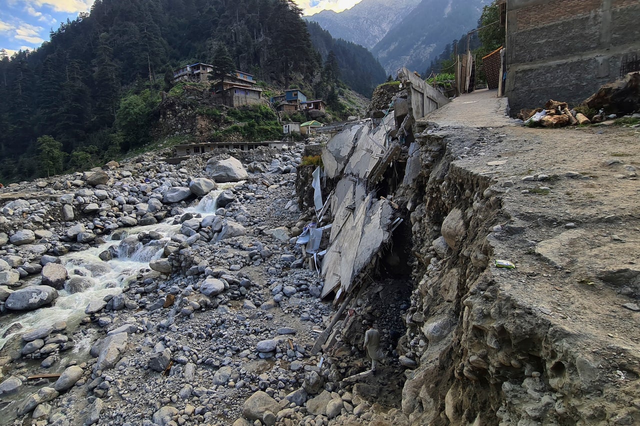 Homes and a portion of road sit destroyed by floodwaters in Kalam Valley in northern Pakistan on Aug. 30, 2022.