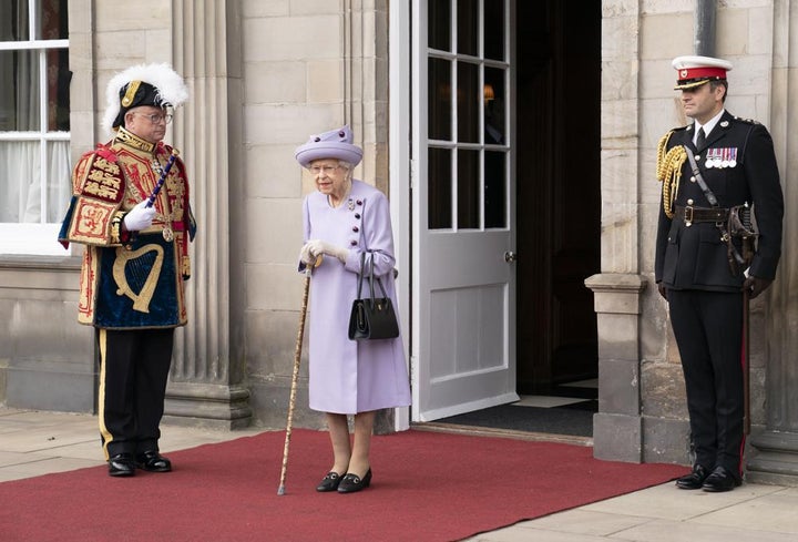 Queen Elizabeth II attends an armed forces act of loyalty parade in the gardens of the Palace of Holyroodhouse, Edinburgh, on June 28.