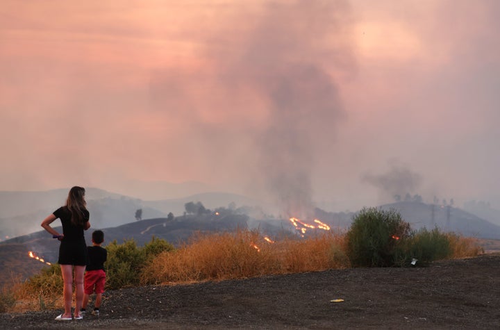A mother stands with her 5-year-old son, whose school was evacuated during the Route Fire, on Wednesday.