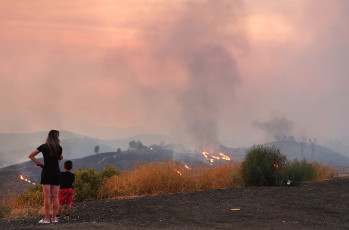 A mother stands with her 5-year-old son, whose school was evacuated during the Route Fire, on Wednesday. 