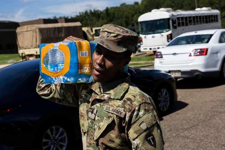Members of the Mississippi National Guard hand out bottled water at Thomas Cardozo Middle School on Sept. 1. 