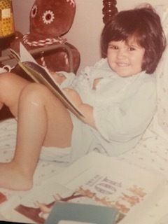 The author reading as a child.