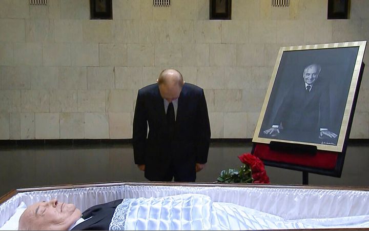 Russian President Vladimir Putin pays his last respect near the coffin of former Soviet President Mikhail Gorbachev at the Central Clinical Hospital in Moscow Russia. (Russian pool via AP)