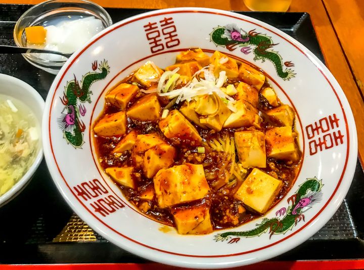 Mapo tofu is a spicy dish flavored with Sichuan peppercorns that make your mouth tingle.