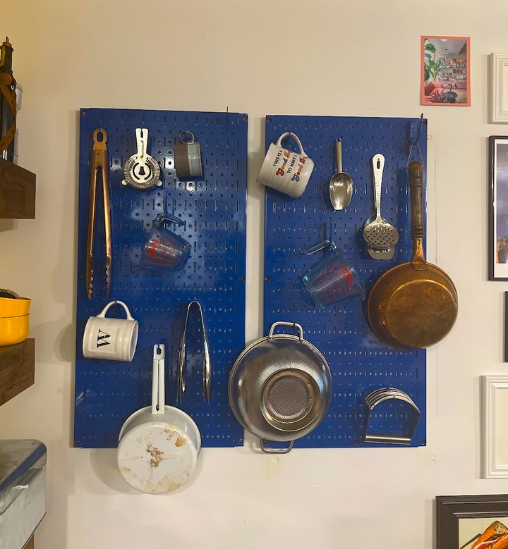 Chef Will Coleman's metal peg board keeps his kitchen organized.