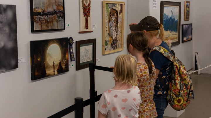 Fairgoers check out Allen's winning artwork in Pueblo, Colorado.