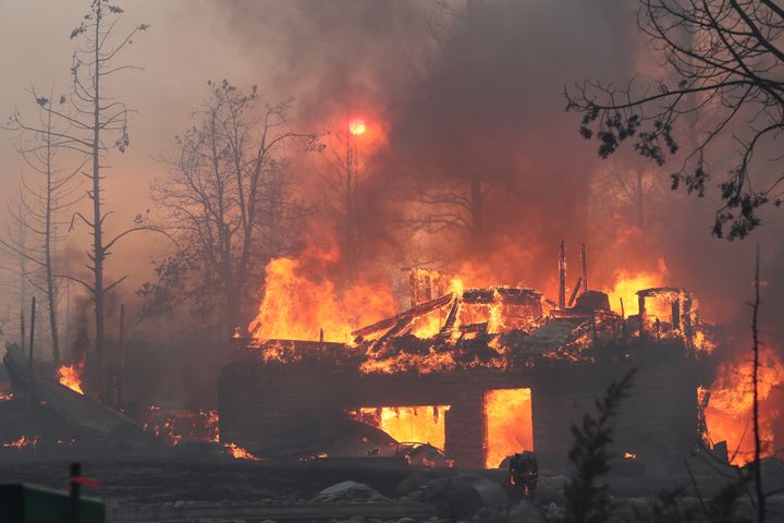 A residence goes up in flames as the Mill Fire causes damage in the Lake Shastina subdivision northwest of Weed, California, Friday, Sept. 2, 2022.