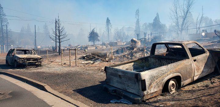 A neighborhood is smoldering after being devastated by the Mill Fire in Weed, California, Friday, September 2, 2022.